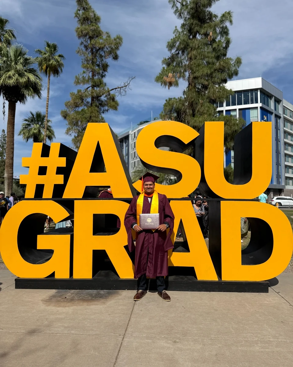 Prakhar Jain in graduation attire beside the complete Arizona State University graduation sign.