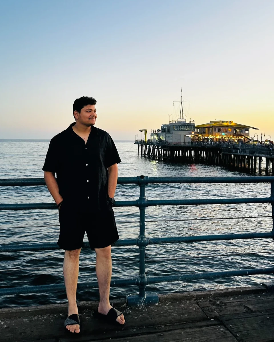Prakhar Jain looking toward the Santa Monica pier with the coastline and water visible.